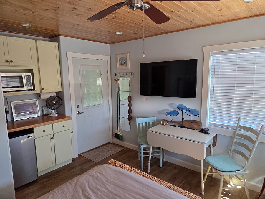 bedroom #1, mini kitchen, tv and entry door.