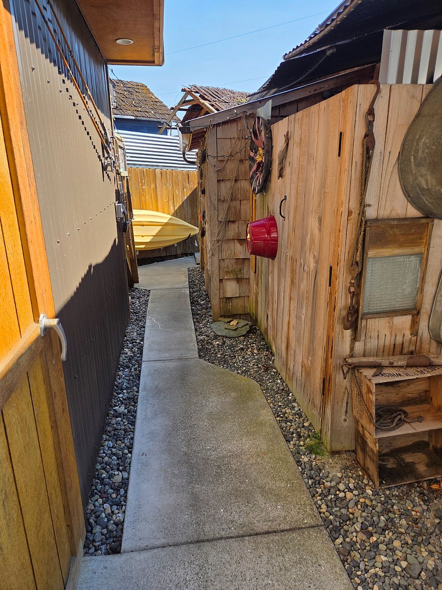 The back sidewalk to the stairs up to the casita and the outdoor shower is to the right.