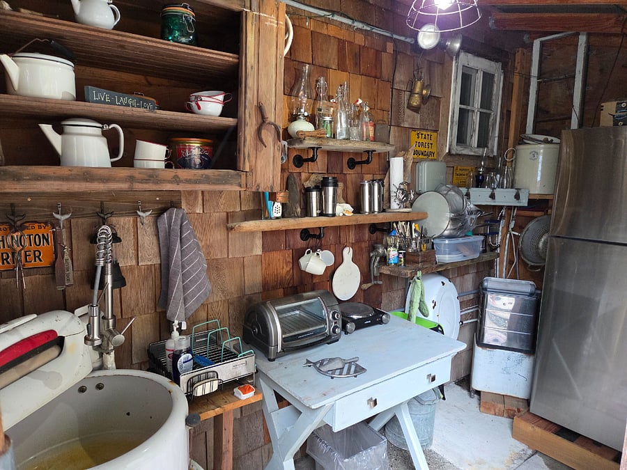 Mini Kitchen stocked with pots, pans and flatware.
