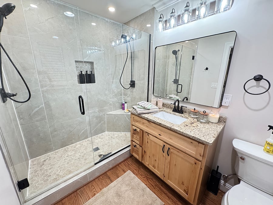 Updated primary suite bathroom with walk-in shower and dual showerhead