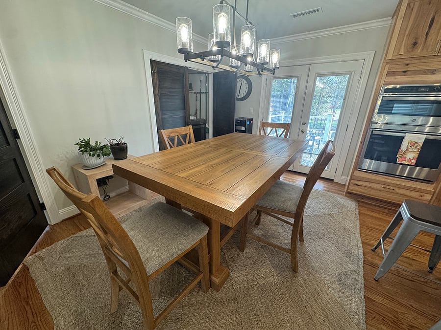 Dining area with laundry closet in background and french doors to the back deck