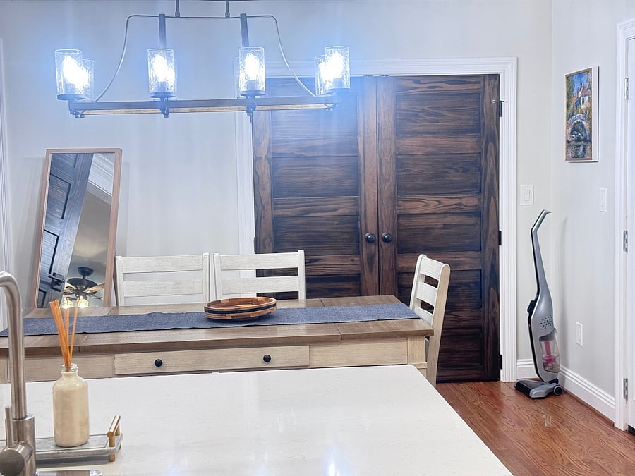 Dining area with laundry closet in background and french doors to the back deck