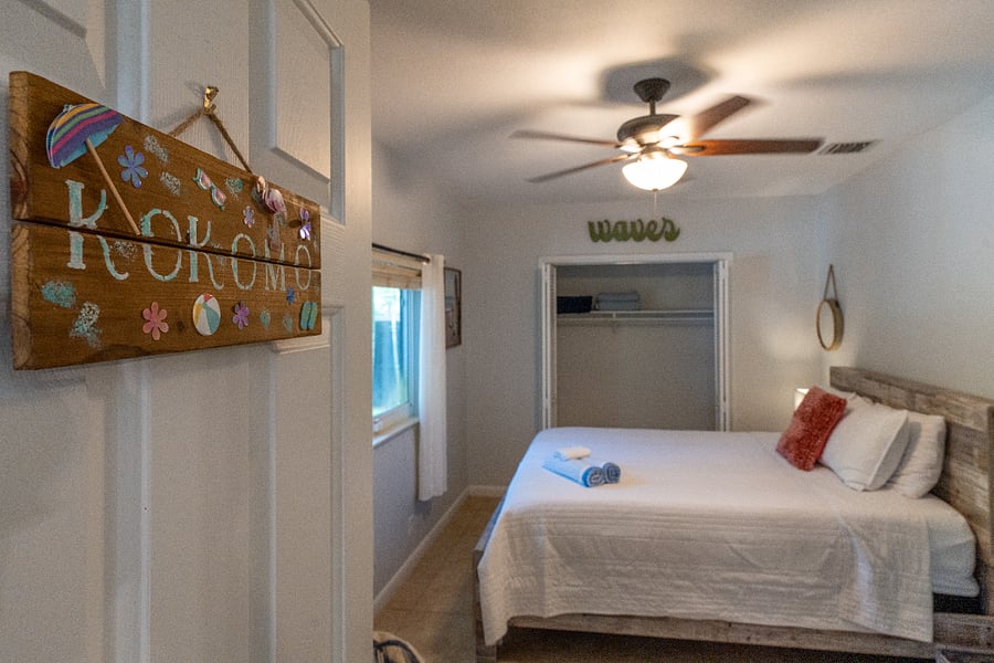 Bedroom 4 with a queen sized bed, closet space, and a TV.