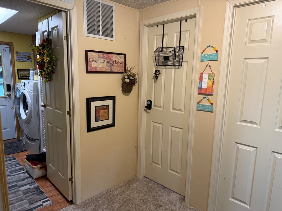 Hallway view: Coded Entrance into (back/main) laundry room, coded lock to your room, guest room.