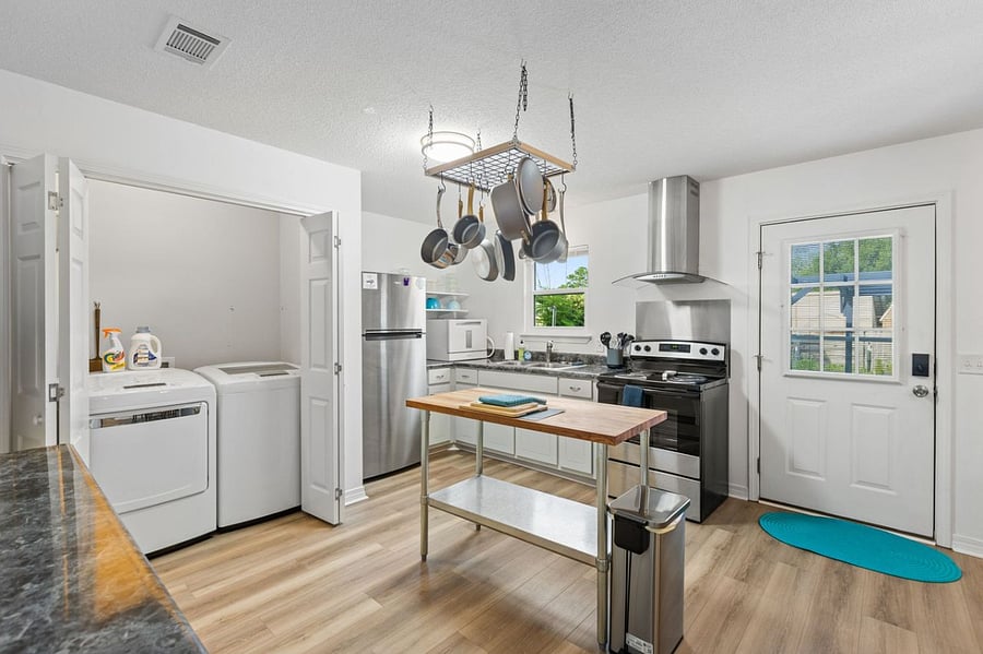 Washer dryer, countertop dishwasher, pots, pans and all you need.