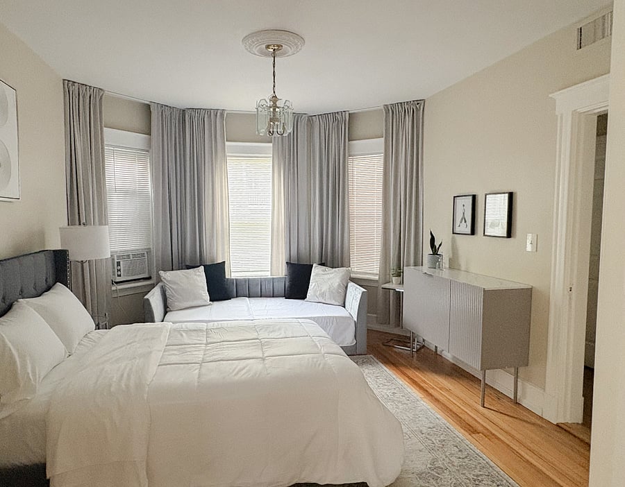 Bedroom 1: Queen bed, sofa bed, storage & cozy dcor for a restful stay.