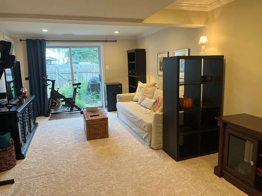 Semi-private living space with mini refrigerator and freezer. Large bookshelf with storage.