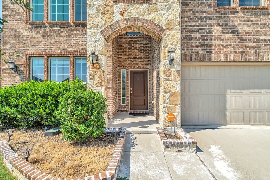 Welcoming stone and brick entry with covered porch. Equipped with a Vivint whole-house security system, including guest access for peace of mind during your stay.
