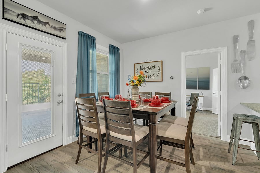 Dining space with seating for eight, filled with natural light and easy access to the covered back patioperfect for family meals or entertaining.