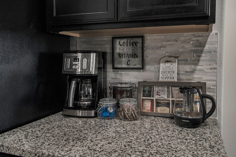 Dedicated coffee and tea bar with premium brewer, tea selection, and essentials for a relaxing start to the day.