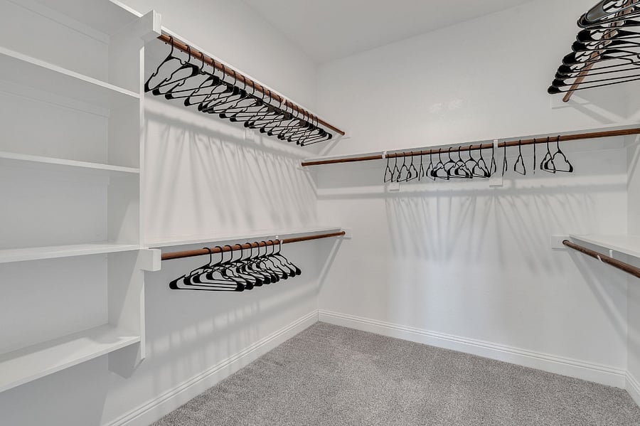 Master bedroom closet with built in shelves.