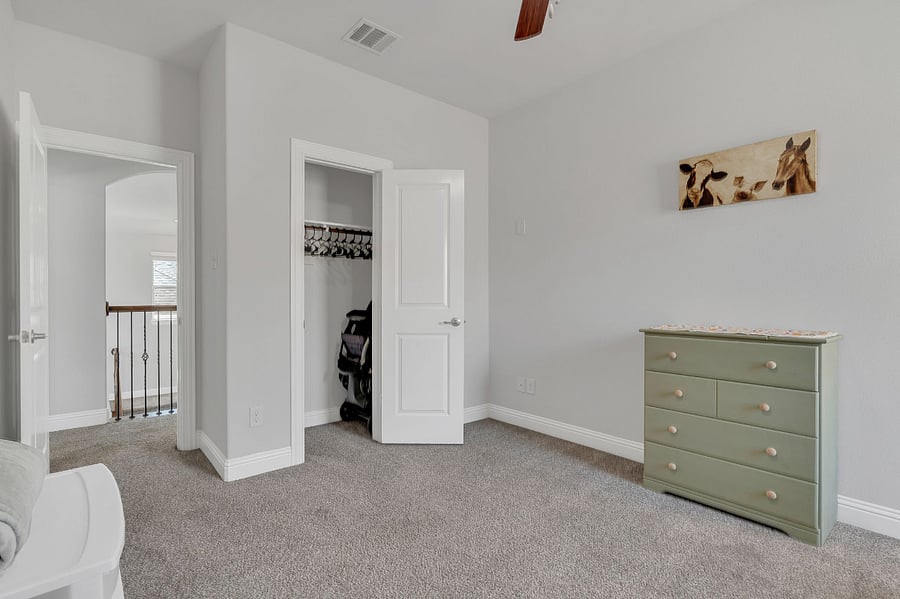 Upstairs 5th bedroom  currently set up as a nursery with a crib, dresser, changing space, and rocking chair. Closet space included. Can be converted to a twin bedroom upon request for additional flexibility.