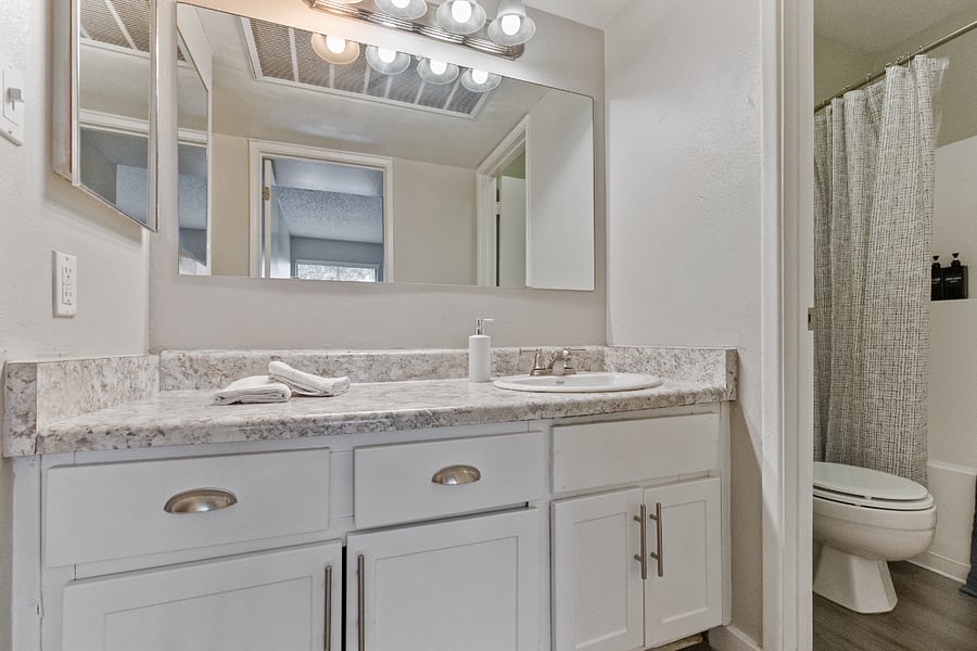 Large vanity mirror and bright lighting.