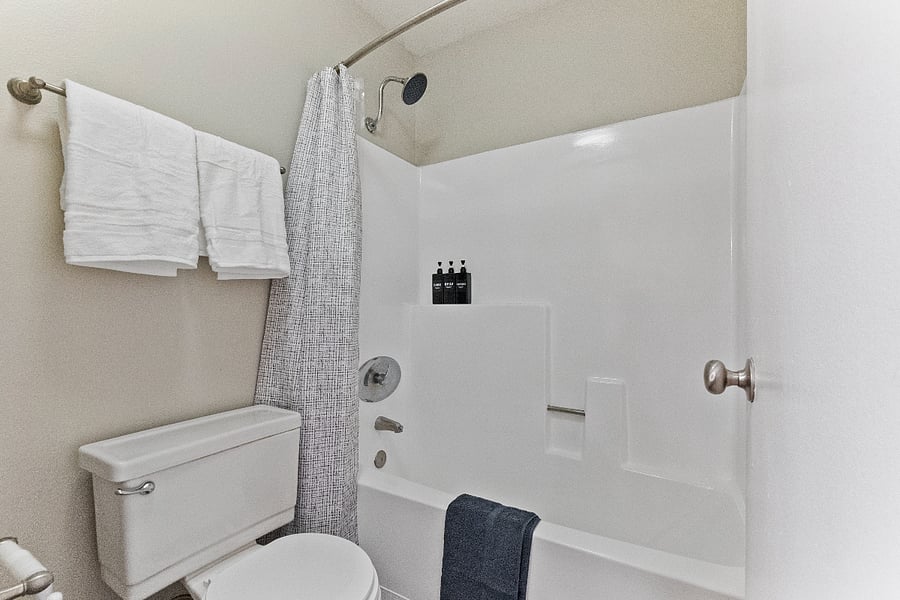  Sleek bathroom with shower-tub combo.