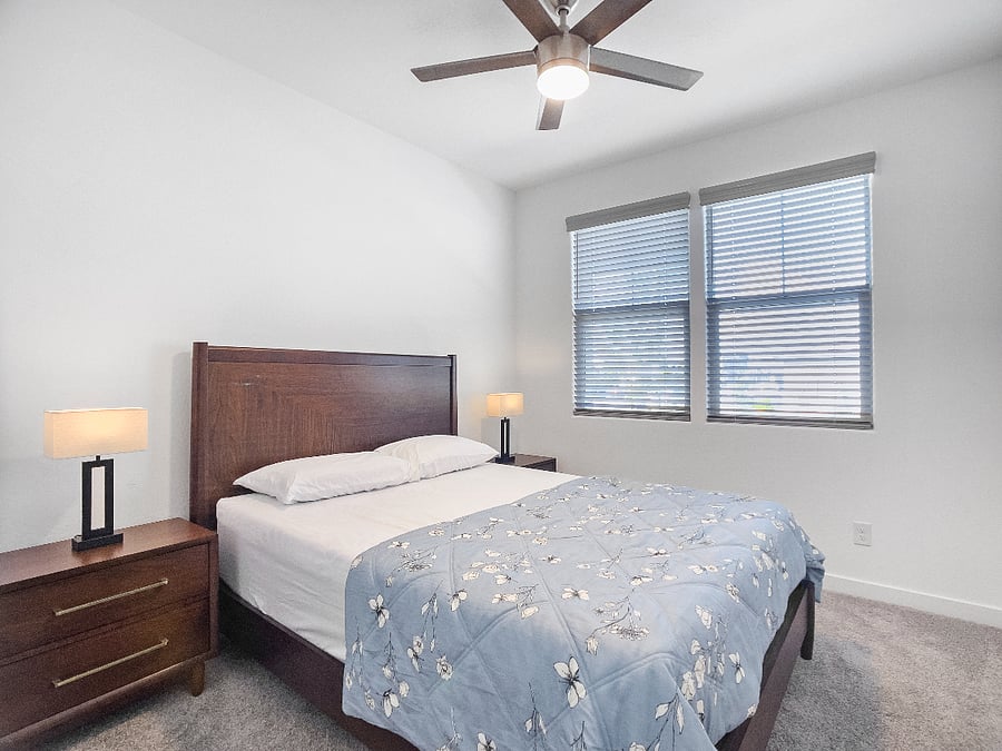 4th bedroom with a brand-new queen-size memory foam bed, 2 nightstands with lamp, ceiling fan, and storage closet. Shares a full bathroom with the 3rd bedroom