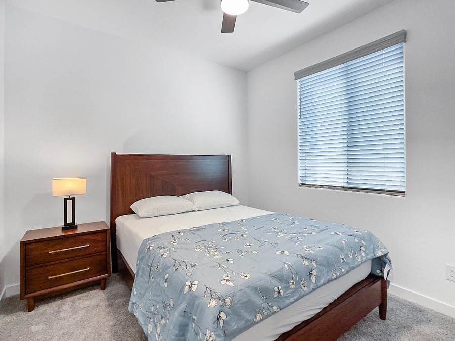 3rd bedroom with a brand-new queen-size memory foam bed, nightstand with lamp, ceiling fan, and storage closet. Shares a full bathroom with the fourth bedroom
