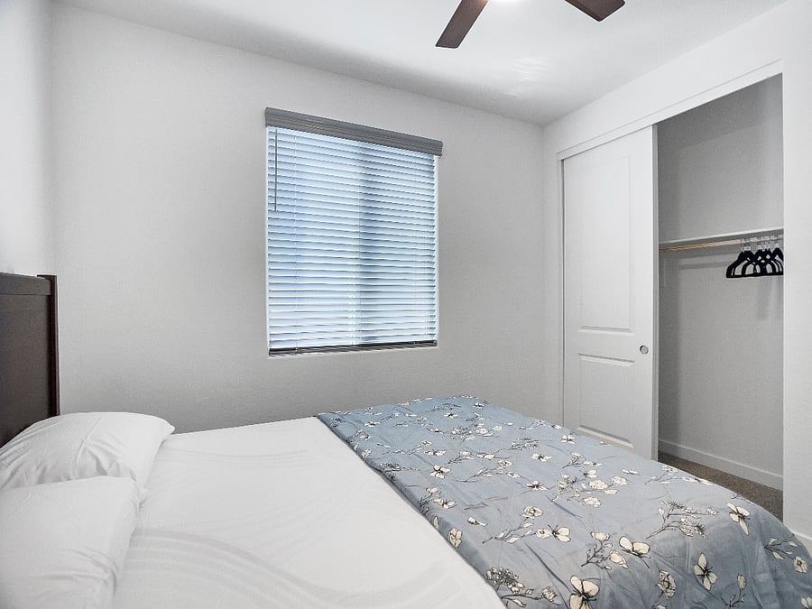 3rd bedroom with a brand-new queen-size memory foam bed, nightstand with lamp, ceiling fan, and storage closet. Shares a full bathroom with the fourth bedroom
