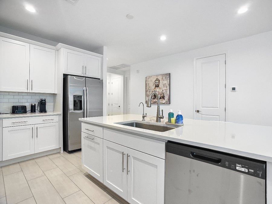 Open kitchen with a spacious island for cooking, sharing meals, and gathering as a family. Includes refrigerator, high bar chairs, toaster, and coffee maker.
Kitchen features a reverse osmosis system for clean, great-tasting drinking water.