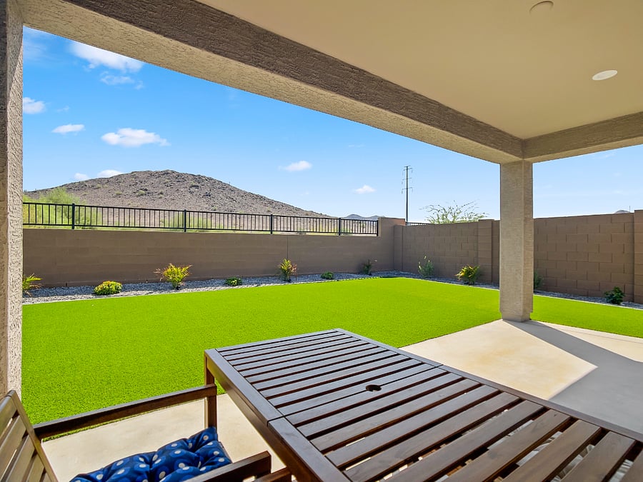 Beautifully landscaped backyard featuring low-maintenance artificial turf, live plants, and full fencing for your pets. Relax on outdoor couches, enjoy family evenings, and unwind under charming ambient lighting for late-night gatherings