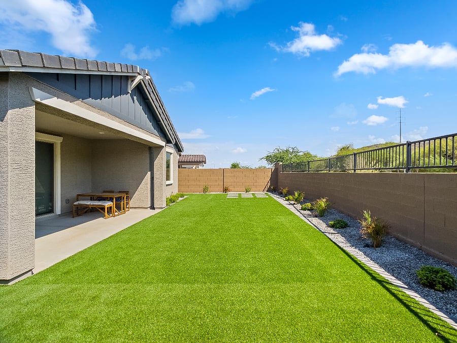 Beautifully landscaped backyard featuring low-maintenance artificial turf, live plants, and full fencing for your pets. Relax on outdoor couches, enjoy family evenings, and unwind under charming ambient lighting for late-night gatherings