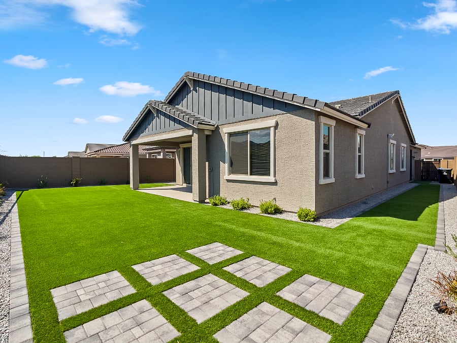 Beautifully landscaped backyard featuring low-maintenance artificial turf, live plants, and full fencing for your pets. Relax on outdoor couches, enjoy family evenings, and unwind under charming ambient lighting for late-night gatherings