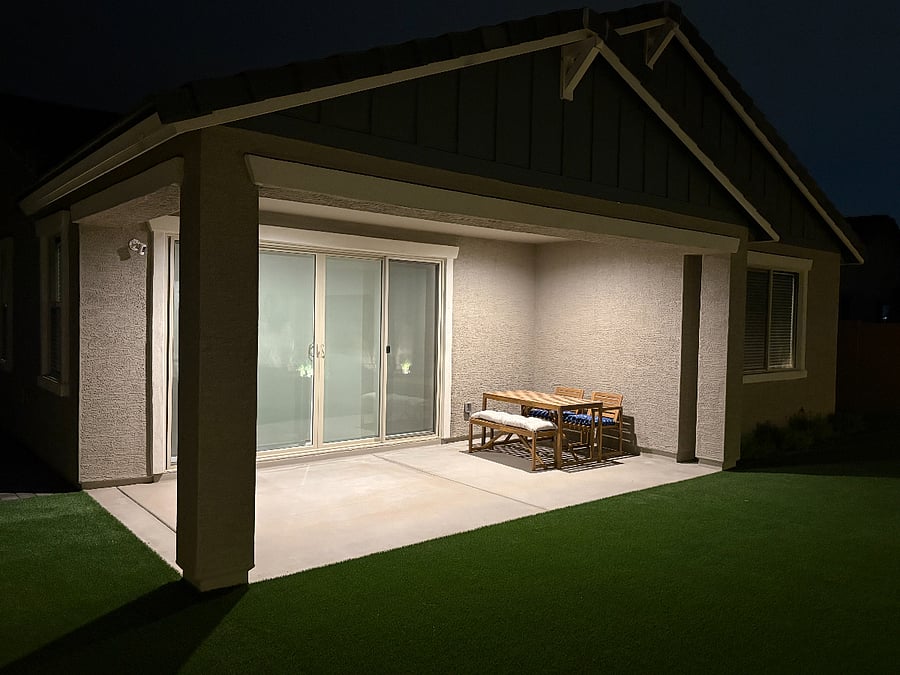 Beautifully landscaped backyard featuring low-maintenance artificial turf, live plants, and full fencing for your pets. Relax on outdoor couches, enjoy family evenings, and unwind under charming ambient lighting for late-night gatherings