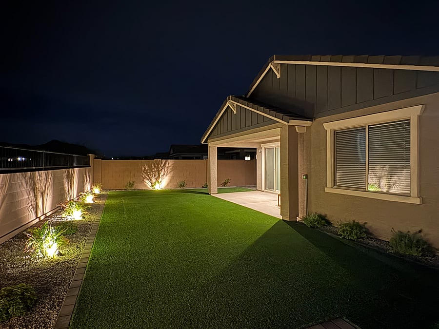 Beautifully landscaped backyard featuring low-maintenance artificial turf, live plants, and full fencing for your pets. Relax on outdoor couches, enjoy family evenings, and unwind under charming ambient lighting for late-night gatherings
