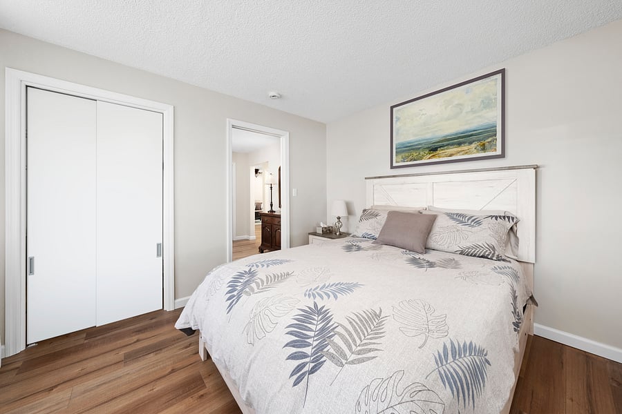 Another view of the front queen bedroom with a comfortable bed, new furnishings, and a large closet.