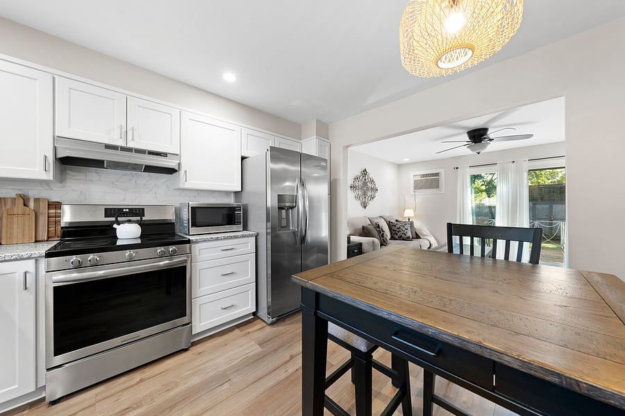Fully equiped eat-in kitchen with new stainless steel appliances, a dishwasher, and seating for four. Open to the living room for easy everyday use.
