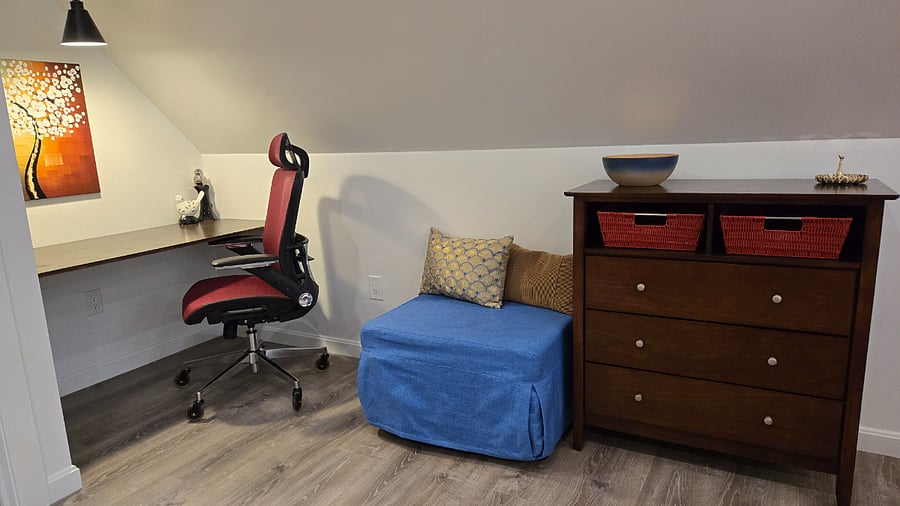 Great designated workspace. The blue ottoman converts to a full-size cot. Besides dresser, there is a closet with hangers, as well as iron and ironing board.
