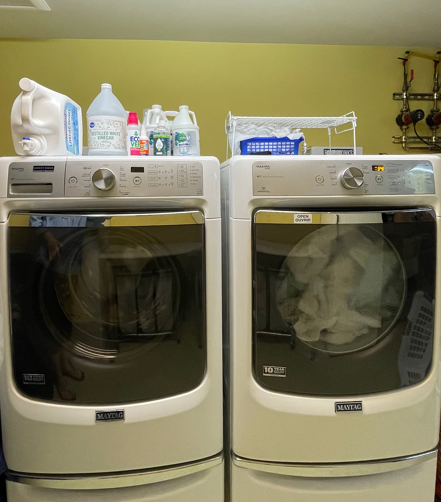 Full-sized washer and dryer in shared laundry room, accessed via locked interior doors