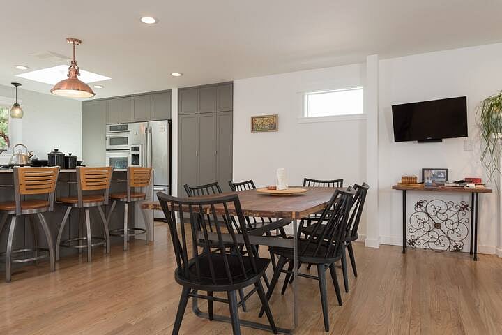 The kitchen is a shared space. There is a piano here you are welcome to play. A door off the kitchen leads to the covered deck, large backyard, and hot tub.