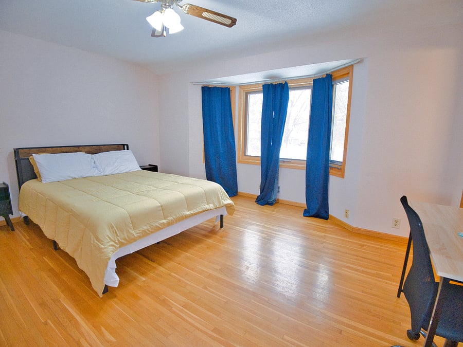 Welcome to your perfect getaway! This charming bedroom offers a cozy queen bed, plush linens, warm decor, and plenty of natural light. Perfect for work or leisure, it's a serene retreat with all the essentials for a restful stay.