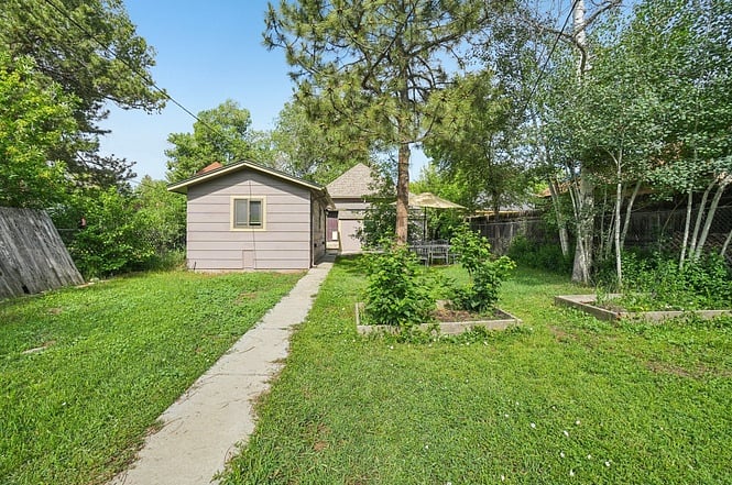 3 garden beds in large fenced-in yard. Alley access.