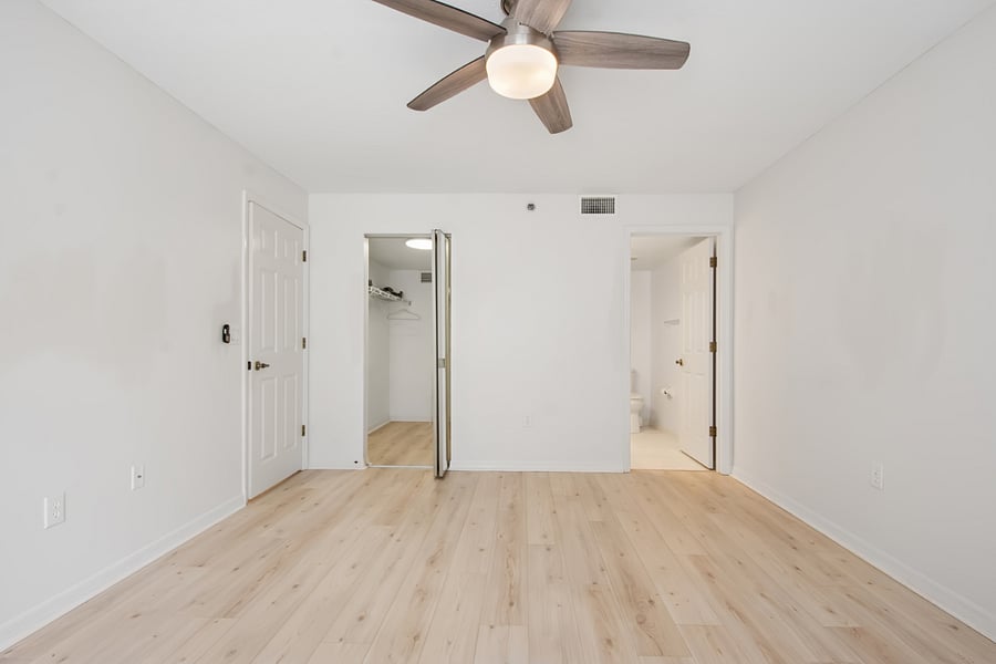 Primary King Bedroom with view of walk-in closet and en-suite bath