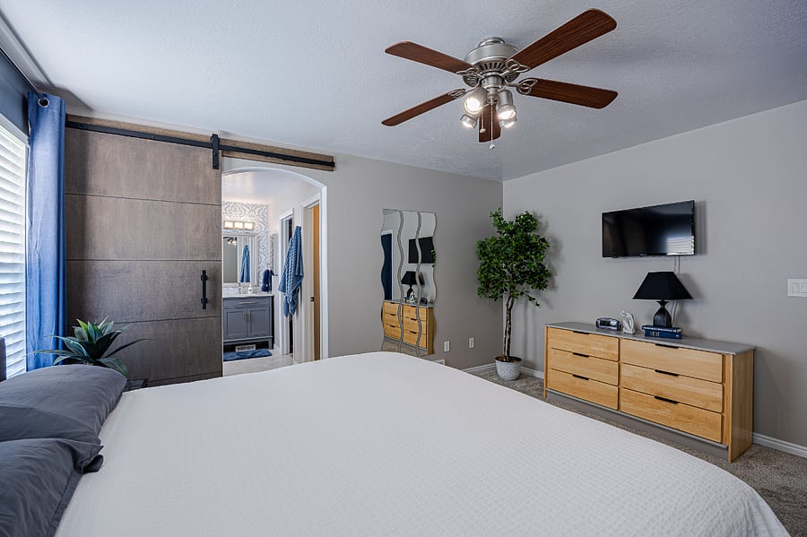 Primary bedroom with barn door to primary bath