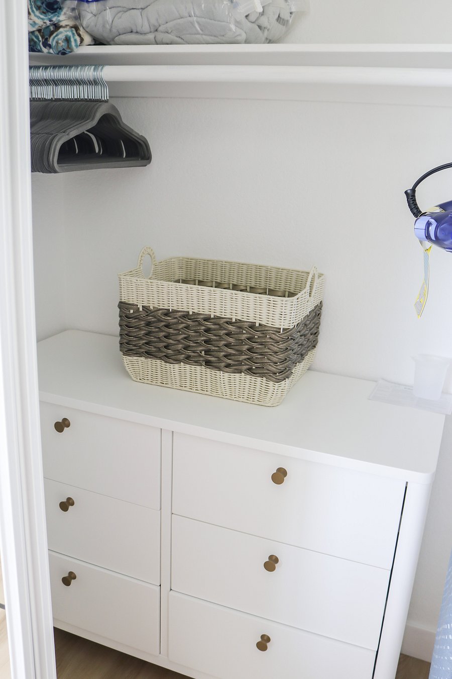 large dresser and convenient laundry basket