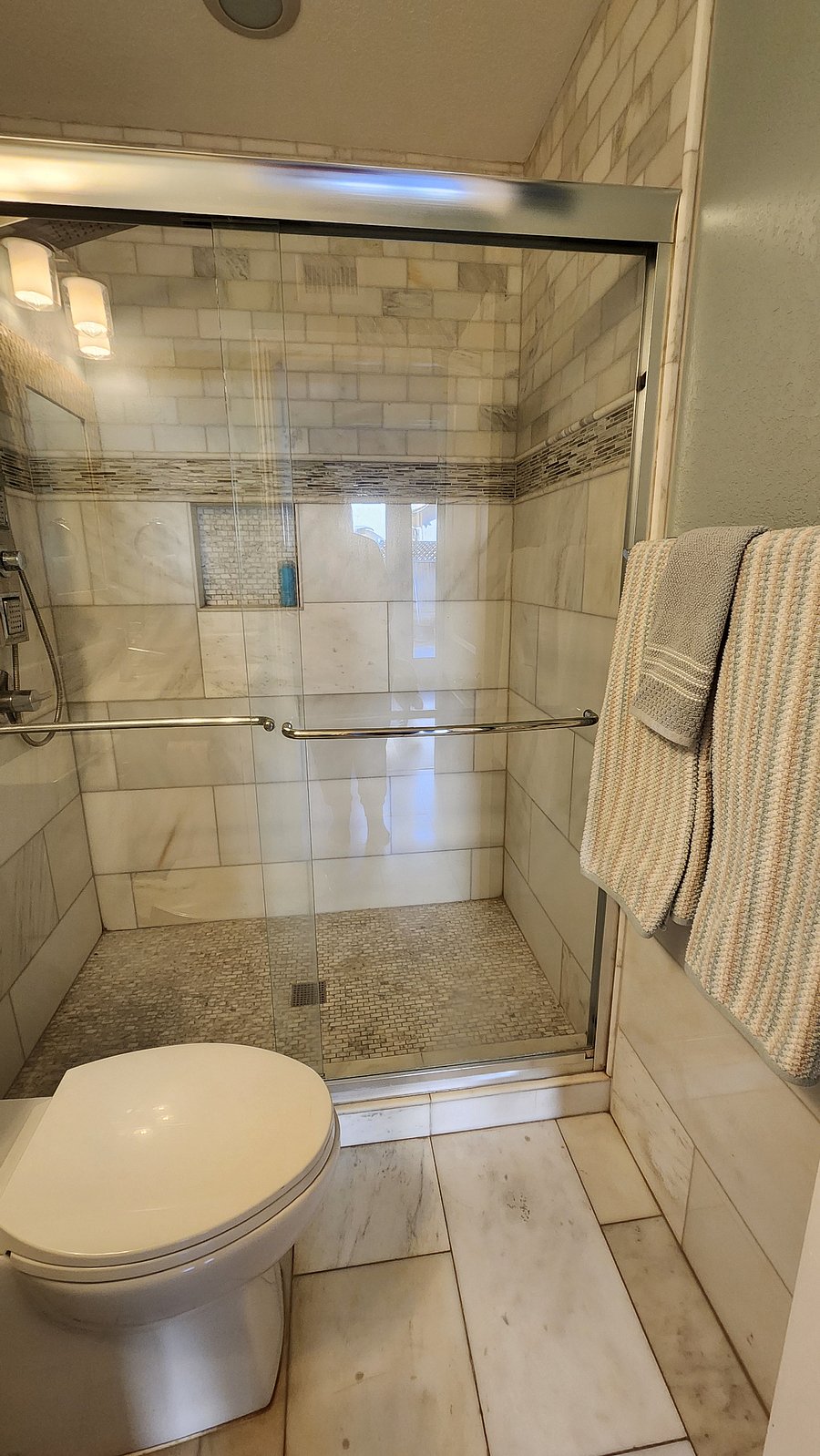 1st floor bathroom, full marble tile with multi-jet shower
