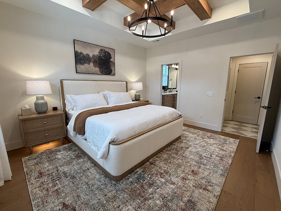King suite with hybrid mattress, oak coffered beams, and lighted nightstands