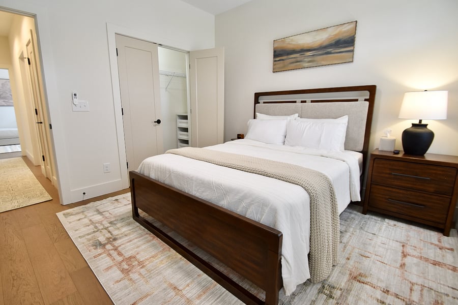 Queen bedding with hybrid mattress and 55-inch ROKU Smart TV with closet system complete with drawers and shoe rack