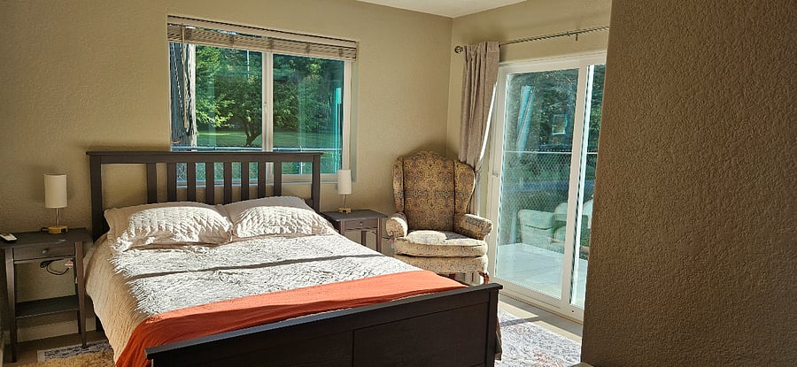 Main bedroom has comfortable queen bed and sliding doors opening onto private patio