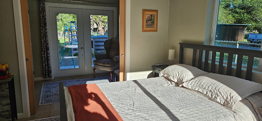 Double pocket doors from bedroom open to a room that could be a child's bedroom, office, sitting room, or perfect place for yoga and meditation