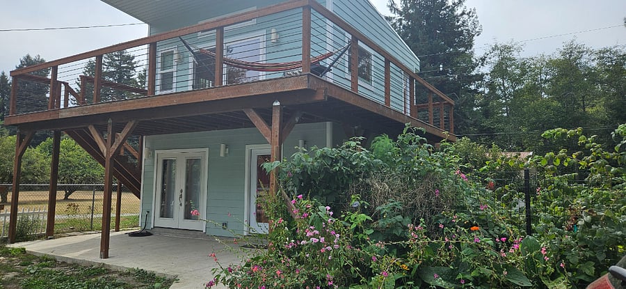The garden features organic vegetables, apple trees, and a variety of berries.
