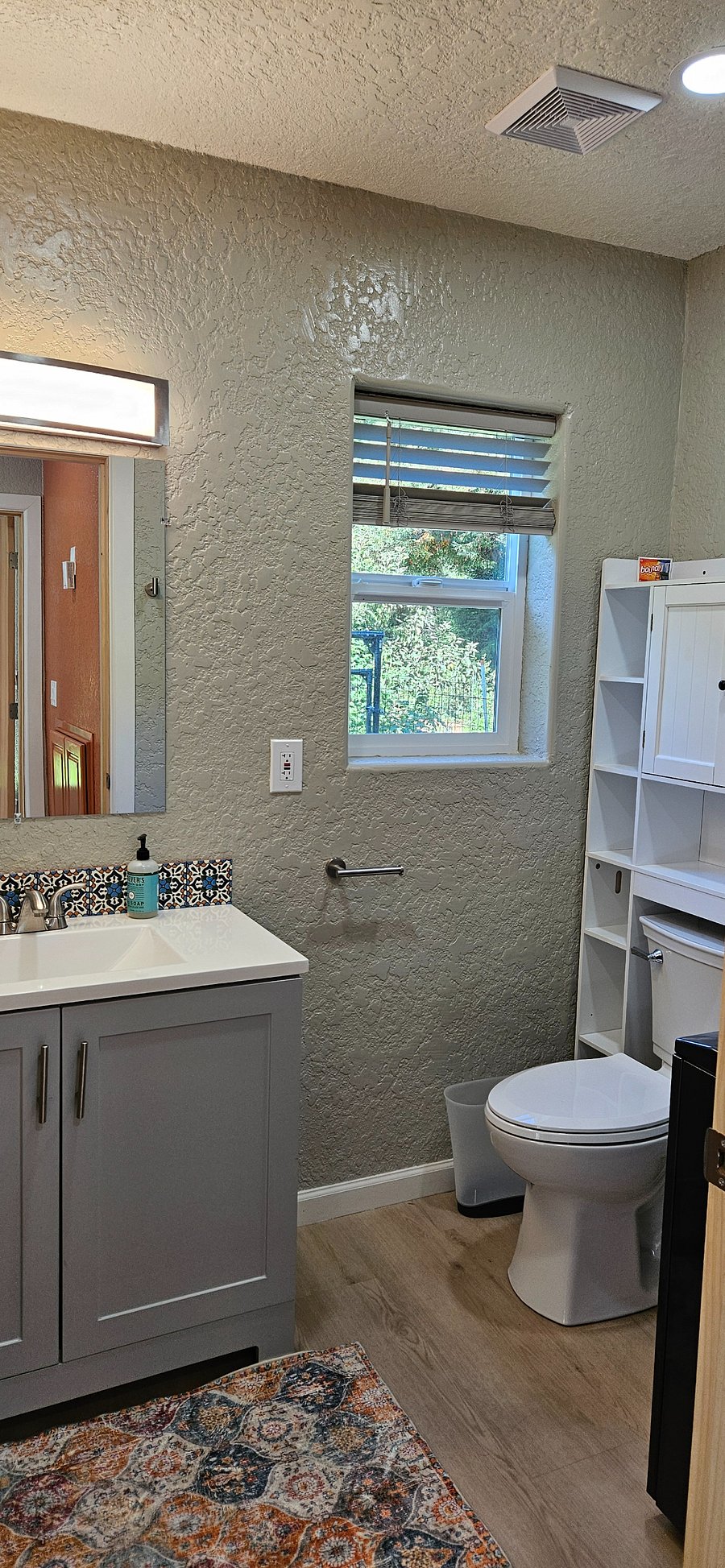 Half bathroom downstairs has toilet, sink, and washer/dryer