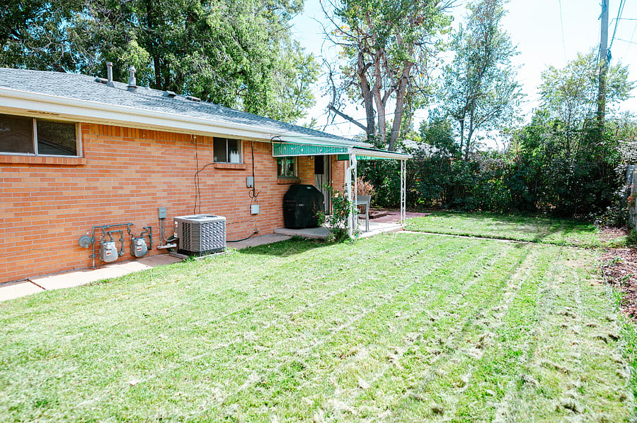 Enclosed backyard with a grill