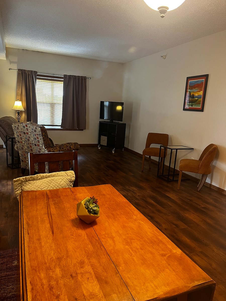 Dining area with smart thermostat and dimmable lighting; living area with smart TV.