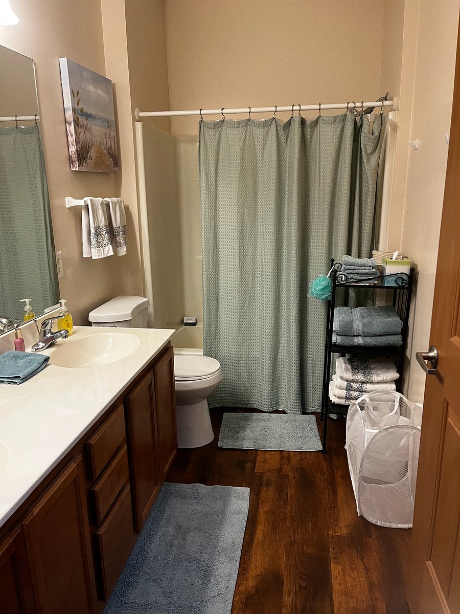 Two sinks, tub with luxury shower head, toilet with attached bidet.