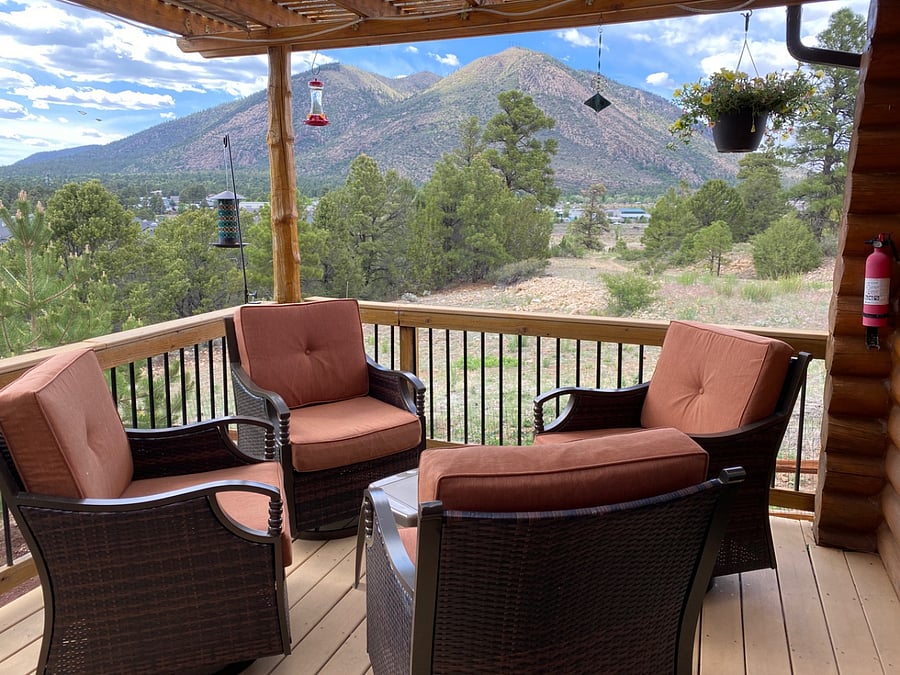 The backyard deck offers great views, a gas fire table, and a picnic table. NEW COVERED DECK AVAILABLE IN DECEMBER 2025!