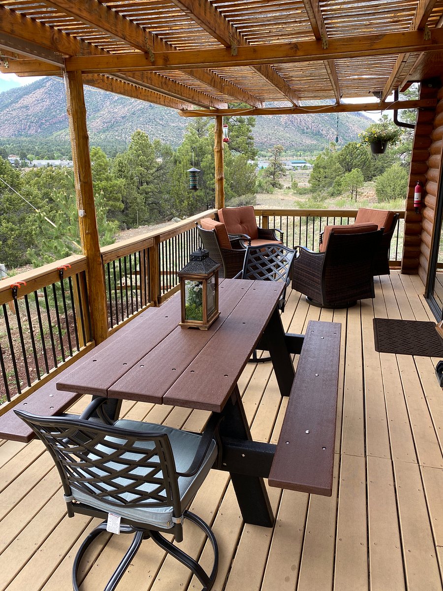 The backyard deck offers great views, a gas fire table, and a picnic table. NEW COVERED DECK AVAILABLE IN DECEMBER 2025!