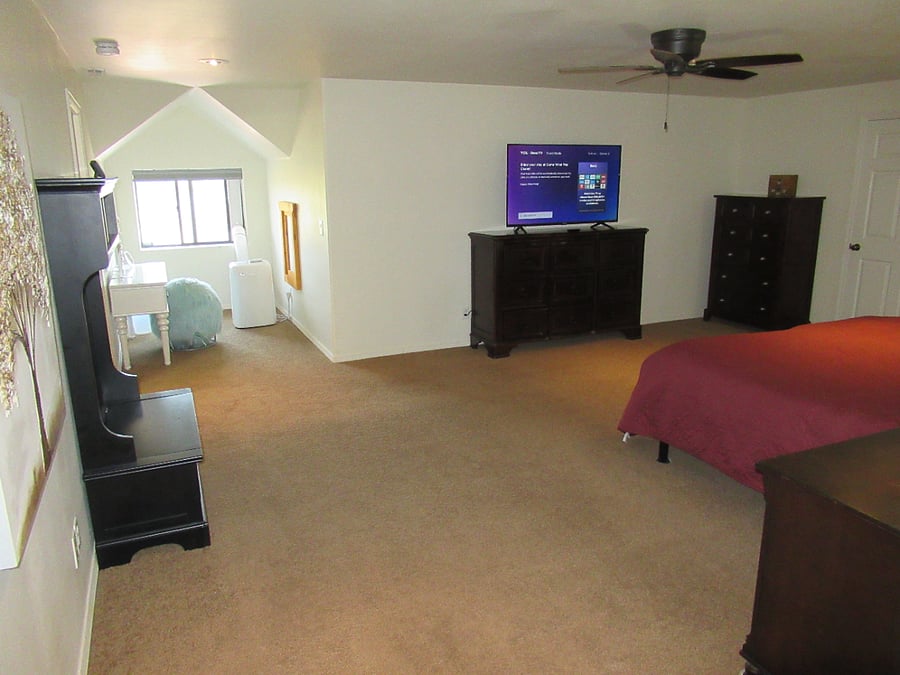 The spacious Master Bedroom features a split-king adjustable bed, a large walk-in closet, a TV (with soundbar)The spacious Master Bedroom features a large walk-in closet, a TV, an reading nook and a vanity. A portable AC unity is available in the summer months.